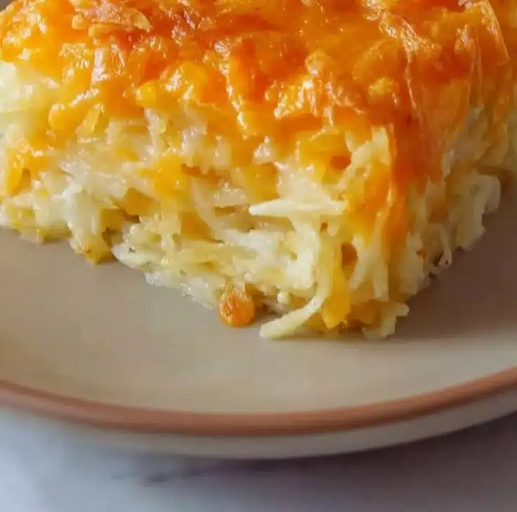 Creamy Cracker Barrel hashbrown casserole topped with cheese and crispy edges