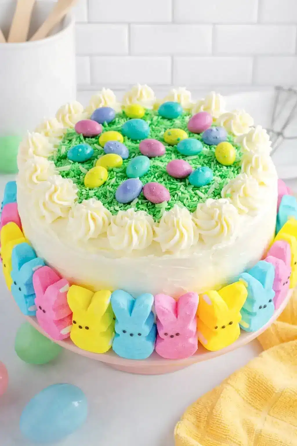Colorful Easter Peep Cake decorated with marshmallow peeps and pastel sprinkles