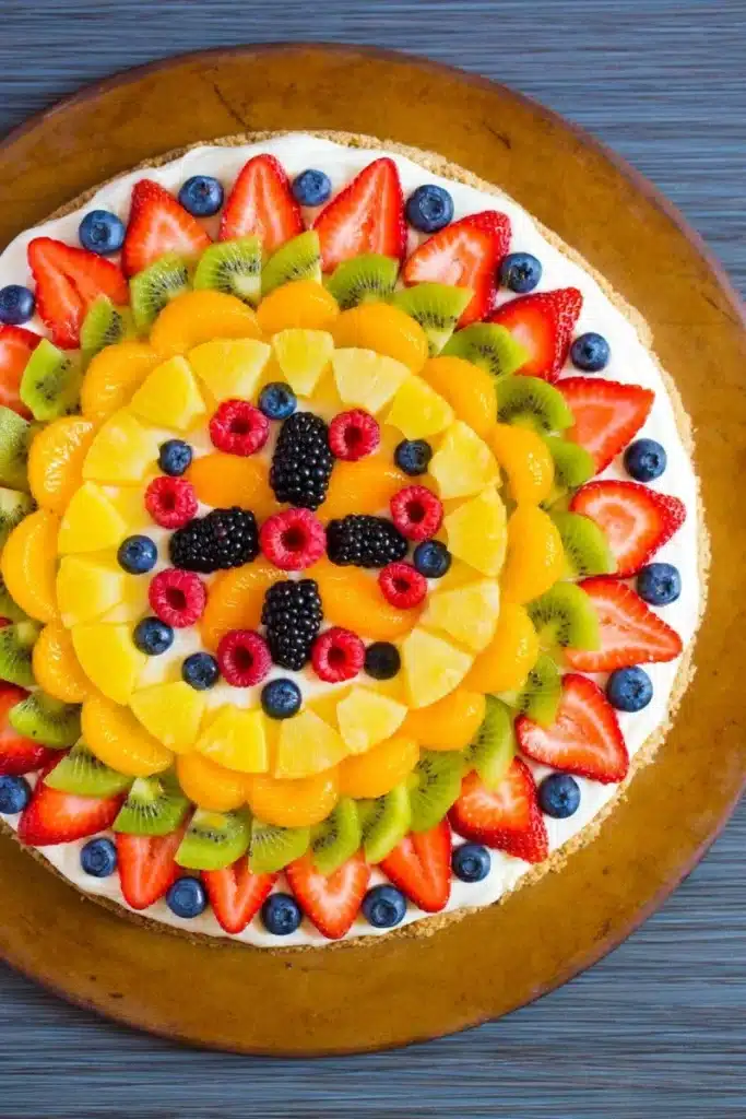 Colorful fruit pizza topped with fresh fruits and a crunchy granola crust.