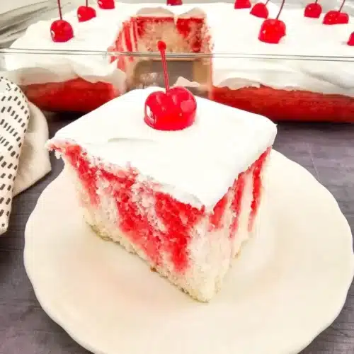 Delicious Jell-O Poke Cake with vibrant colors and creamy topping