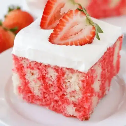 Delicious Jello Poke Cake with colorful jelly topping and whipped cream