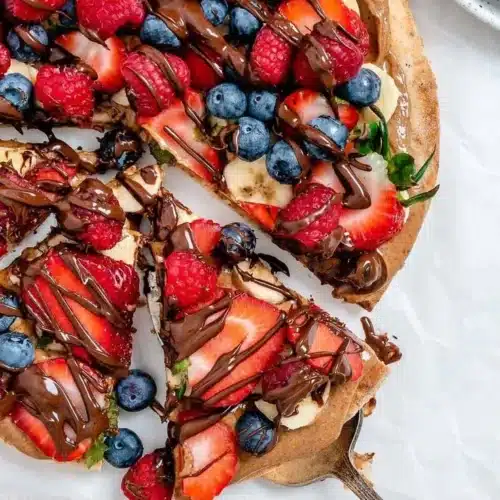 Colorful Summer Fruit Pizza topped with fresh seasonal fruits on a cookie base.