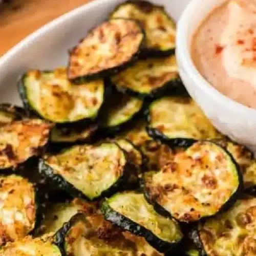 Crispy air fryer zucchini slices in a bowl, ready to serve.